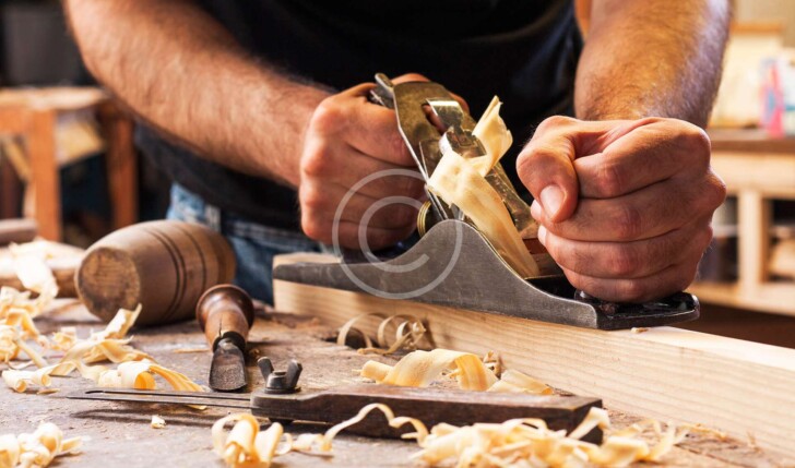 Man carving wooden board
