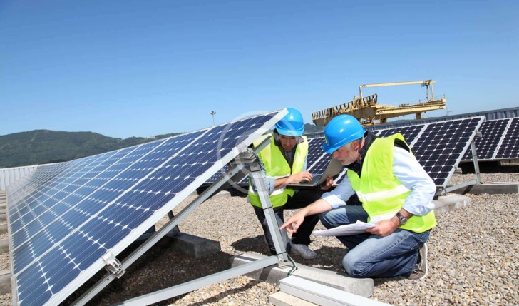 workers discussing solar panels
